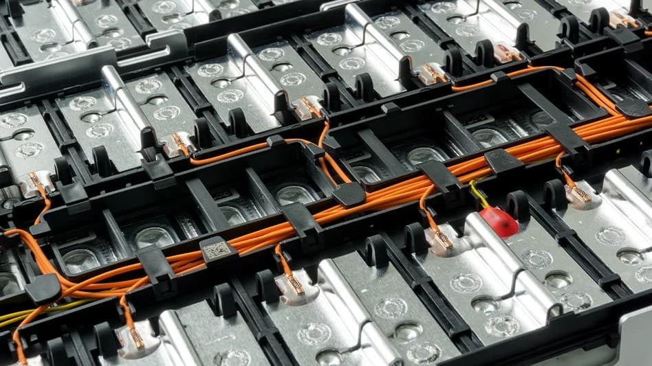Battery metals powering high-voltage EV cells with orange wiring and metal casing